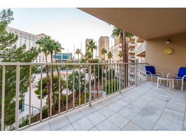 Spacious balcony with city views and seating for two at 205 E Harmon Ave # 609, Las Vegas, NV 89169