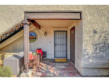 Inviting condo entry with tile flooring, wrought iron door, and stained glass accents at 5066 Jeffreys St # 101, Las Vegas, NV 89119