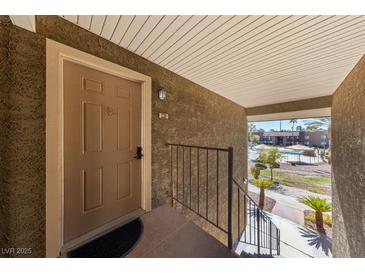 Condo entryway with view of pool and community at 5098 River Glen Dr # 220, Las Vegas, NV 89103