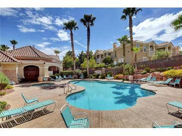 Inviting community pool with lounge chairs and a spa at 5855 Valley Dr # 2045, North Las Vegas, NV 89031