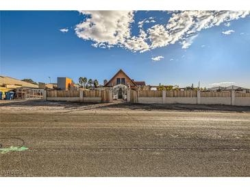 A charming one-story home with a unique architectural style and a fenced yard at 919 Havre Ave, Henderson, NV 89015