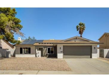 Single-story home with solar panels, attached garage, and landscaped yard at 2600 Congress Ave, Las Vegas, NV 89121
