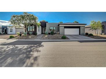 Single-story home with modern facade, two-car garage, and landscaped front yard at 4829 E Beacon Ridge Dr, Pahrump, NV 89061