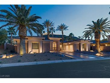 Stunning desert home with palm trees and a large driveway at 1665 Liege Dr, Henderson, NV 89012