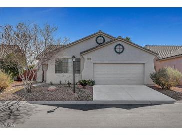Charming single-story home boasts a two-car garage, low maintenance landscaping, and lots of curb appeal at 5919 Pavilion Lakes Ave, Las Vegas, NV 89122