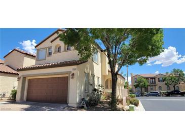 Two-story house with attached garage and landscaping at 12064 Avery Meadows Ave, Las Vegas, NV 89138