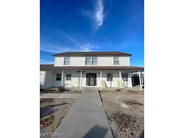 Two-story house with front porch and walkway at 1590 Mustang Dr, Henderson, NV 89002