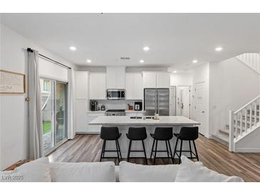 Modern kitchen with island, stainless steel appliances, and white cabinetry at 600 N Carriage Hill Dr # 1108, Las Vegas, NV 89138