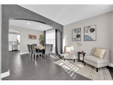 Spacious dining room with a large table and chairs, and views into the kitchen at 1204 Airborne Ct, North Las Vegas, NV 89032