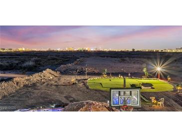 Expansive backyard featuring putting green, basketball court, desert landscape, and a stunning Las Vegas skyline view at 12745 Fairfield Ave, Henderson, NV 89044