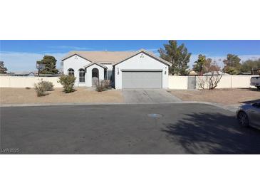 Single-story house with a two-car garage and landscaped front yard at 2142 Seattle Shore St, Las Vegas, NV 89115