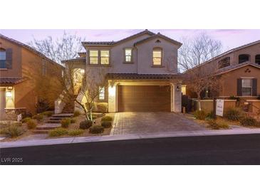 Two-story home with a landscaped yard and a three-car garage at 483 Astillero St, Las Vegas, NV 89138