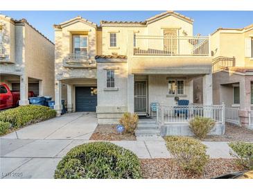Two-story house with balcony, porch, and attached garage at 9068 Alluring Ave, Las Vegas, NV 89149