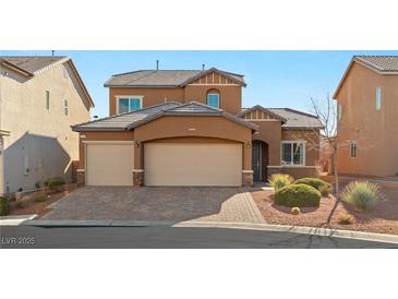 Two-story house with three-car garage and landscaped front yard at 10509 Ingelow Ct, Las Vegas, NV 89166