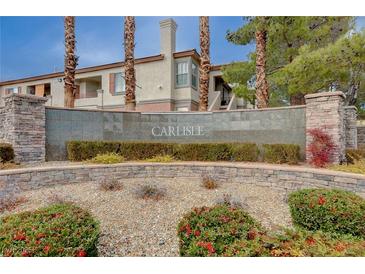 Elegant community signage featuring the name Carlisle, set amidst lush landscaping and stately architecture at 1701 King James St # 101, Las Vegas, NV 89144