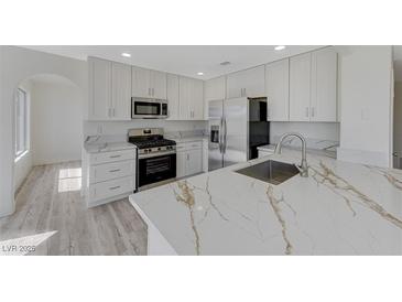 Modern kitchen with stainless steel appliances and white cabinets at 1901 Camino Carlos Rey, North Las Vegas, NV 89031