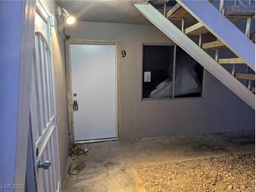 Exterior view of a building with stairs and a white door at 208 Orland St # 9, Las Vegas, NV 89107
