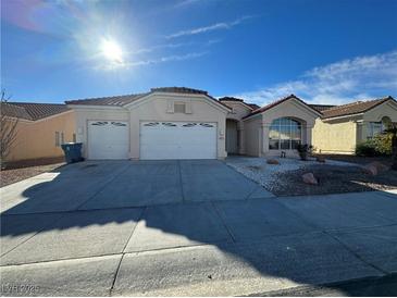 Single-story house with three-car garage and landscaped front yard at 8545 Summer Vista Ave, Las Vegas, NV 89145