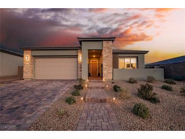 Single-story home with stone accents and a two-car garage at 140 Springbough Ln, Las Vegas, NV 89138