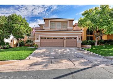 Two-story house with a two-car garage and landscaped lawn at 316 Pleasant Summit Dr, Henderson, NV 89012
