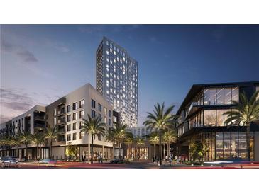 Modern highrise building with palm trees and city street view at dusk at 700 W Carson Ave # 1401, Las Vegas, NV 89106