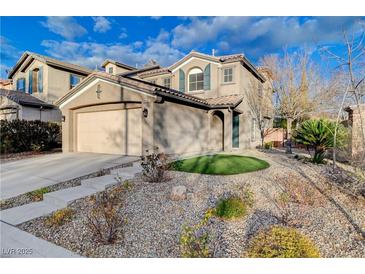 Two-story house with beige exterior, landscaping, and a two-car garage at 848 Percy Arms St, Las Vegas, NV 89138