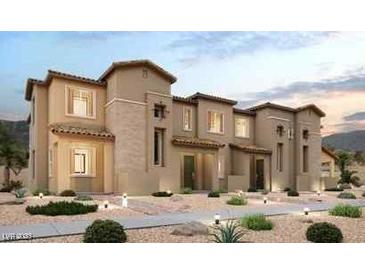 Tan two-story townhome with Spanish-style architecture and desert landscaping at 192 Freeport View Pl, Henderson, NV 89011