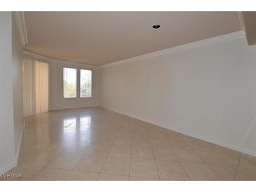 Bright living room features neutral paint, and sleek tile flooring for a modern and clean aesthetic at 270 E Flamingo Rd # 211, Las Vegas, NV 89169