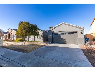 Single-story house with gray exterior, attached garage, and landscaping at 2712 Peekskill Ave, Henderson, NV 89052