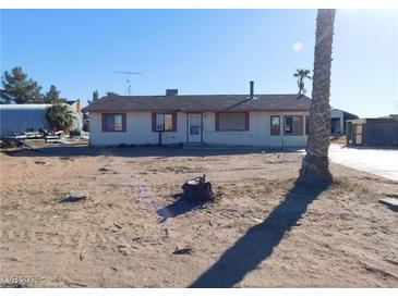 Modest single-story house on a large lot with desert landscaping and limited improvements at 3748 Skyline St, Logandale, NV 89021