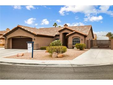 Single-story home with a brown exterior, tile roof, and landscaped front yard at 5445 Rose Hills St, Las Vegas, NV 89149