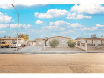 Single-story house with a landscaped yard and driveway at 6215 Newville Ave, Las Vegas, NV 89103
