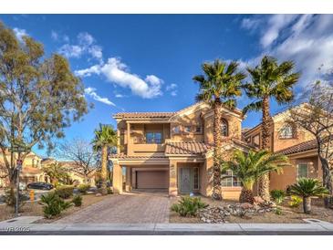 Two-story house with a large driveway and palm trees in front at 7642 Riva Ridge St, Las Vegas, NV 89149