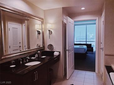 Elegant bathroom with a large vanity, soaking tub, and separate shower at , Las Vegas, NV 89109