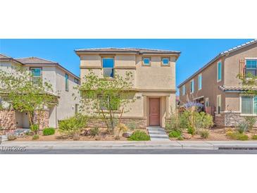 Charming two-story home with manicured front yard and neutral colored stucco exterior at 2694 Marvel Astoria St, Henderson, NV 89044