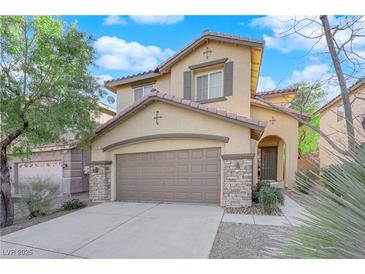 Two-story house with a brown garage door and stone accents at 9161 Horizon Mist Ave, Las Vegas, NV 89178