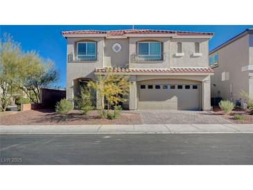 Two-story house with a two-car garage and well-manicured landscaping at 10306 Coastline Creek Ct, Las Vegas, NV 89141