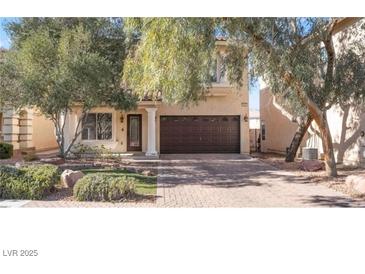 Two story house with a brown door and two car garage at 11017 Ladyburn Ct, Las Vegas, NV 89141