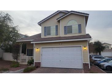 Two-story house with attached garage and landscaped front yard at 1529 Tillman Falls Ave, Las Vegas, NV 89183