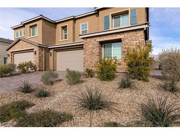 Two-story home with stone accents and landscaped front yard at 1642 Dire Wolf Ave, North Las Vegas, NV 89084