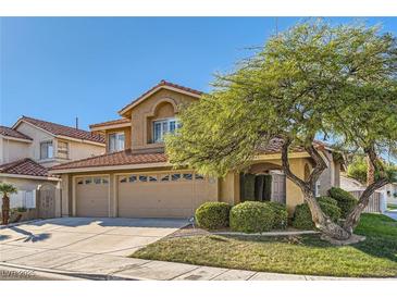 Two-story house with three-car garage and landscaped yard at 1901 Summit Pointe Dr, Las Vegas, NV 89117