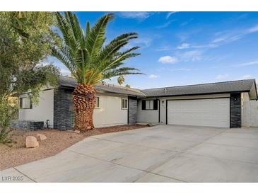 Updated single-story home with a two-car garage and desert landscaping at 4457 Dennis Way, Las Vegas, NV 89121