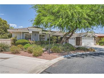 Single-story home with gray siding, mature tree, and two-car garage at 7456 Ute Meadows Cir, Las Vegas, NV 89129