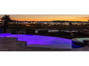 Luxury pool with city views at sunset; spa and landscape lighting at 1 Panorama Crest Ave, Las Vegas, NV 89135