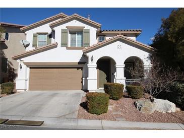 Two-story house with a tan garage door and landscaping at 10418 Prairie Mountain Ave, Las Vegas, NV 89166