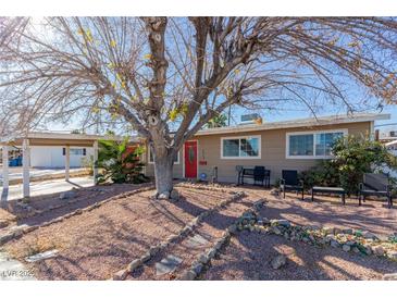 Ranch house with red door, carport, and landscaped front yard at 2828 Richfield Blvd, Las Vegas, NV 89102