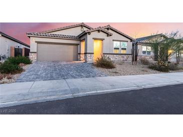 Single-story home with a two-car garage and landscaped front yard at 3540 Valley Lily St, North Las Vegas, NV 89032