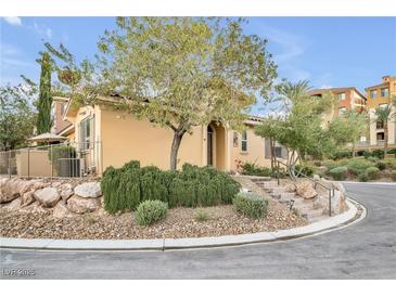 Tan two-story home with landscaped yard and stone accents at 4 Via Centrale # 1, Henderson, NV 89011