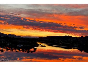 Scenic sunset view over water reflecting the colorful clouds and mountains in the background at 4 Via Centrale # 1, Henderson, NV 89011