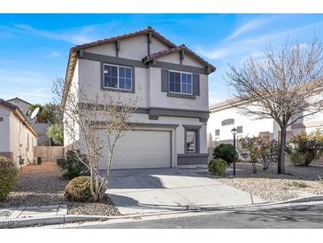 Two-story house with attached garage, landscaping, and light-colored exterior at 4439 Yellow Harbor St, Las Vegas, NV 89129